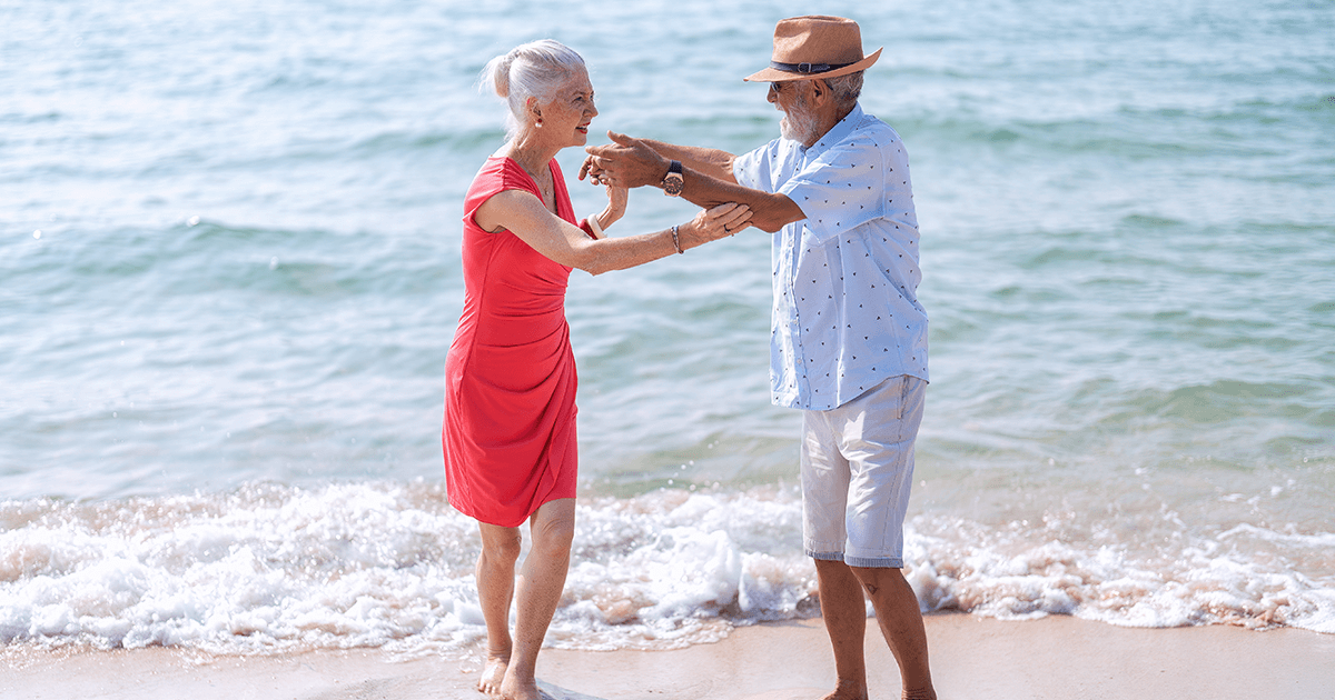 Elderly Couple Dancing at Beach