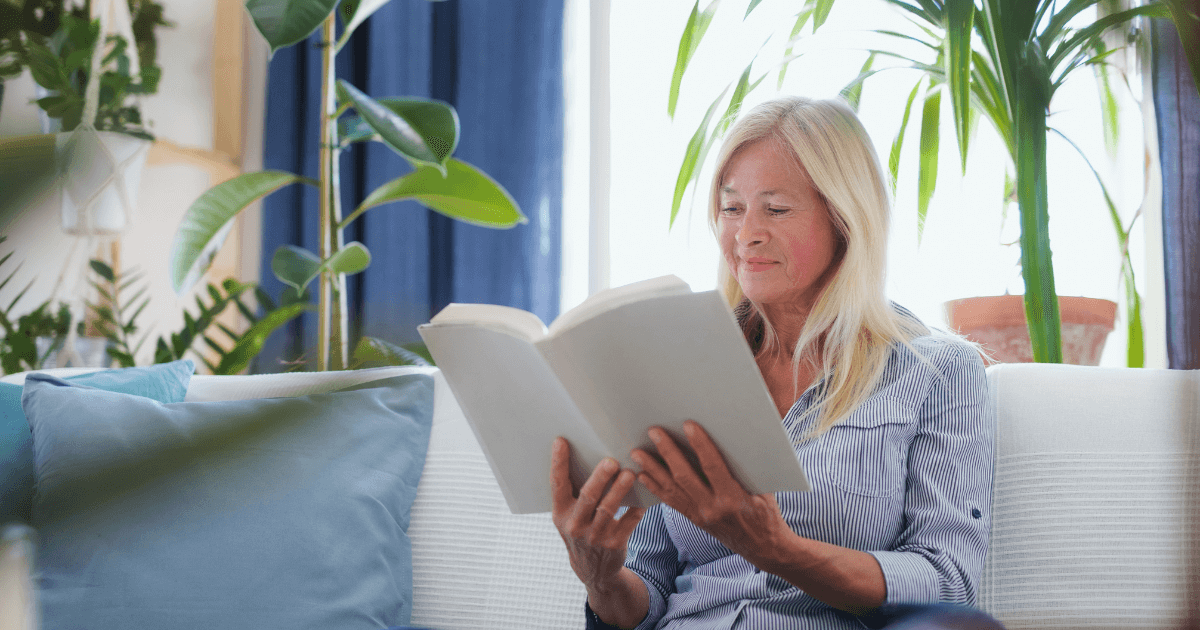 senior woman reading a book while enjoying her new home improvements