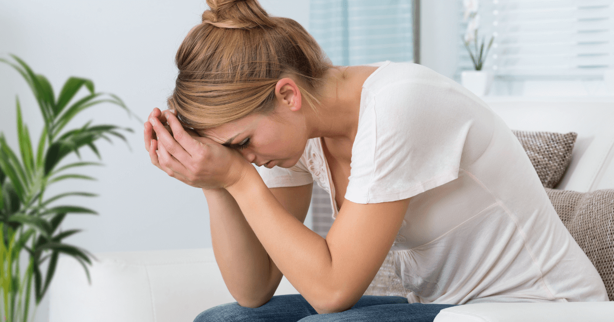 woman sitting at home feeling caregiver burnout